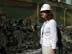 An engineer inspects material removed from a boiler during renovation at the Al-Doura power plant in Baghdad. Tests will be done to check for dangerous material such as asbestos. USAID is funding the repair of Iraq's nationwide electrical system.