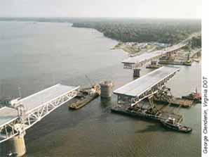 Barges float a truss span into place for the new Coleman Bridge, which carries Route 17 over the York River in Yorktown, VA.