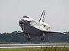 A space shuttle orbiter landing on the hard surface at NASA's Kennedy Space Center in Florida