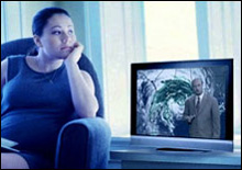 photo: A woman watching a weather report.
