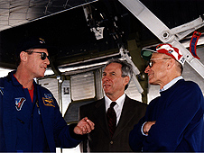 Bob Sieck, right, astronaut Michael Baker, left, and then-NASA Administrator Dan Goldin talk after a shuttle landing.