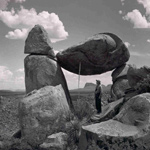 Park Ranger standing beneath the balanced rock, 1950s