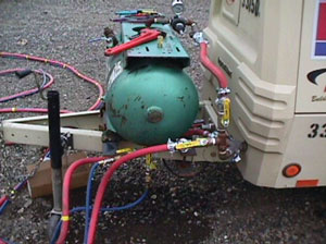 Water tank mounted on compressor trailer.
