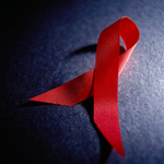 Photo of AIDS ribbon on blue background