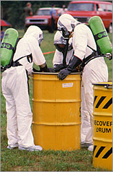 people in protective suits handling toxic material