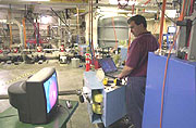 Joe Gubeli, Jefferson Lab staff engineer, works on the Lab's Free-Electron Laser in preparation for bringing the upgraded machine on line.