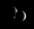 Dione and Rhea pair up for an occultation, or mutual event, as seen by 
Cassini. While the lit portion of each moon is but a crescent, the dark 
side of Dione has begun to take a bite out of its distant sibling moon