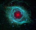 
This infrared image from NASA's Spitzer Space Telescope shows the Helix nebula, a cosmic starlet often photographed by amateur astronomers for its vivid colors and eerie resemblance to a giant eye