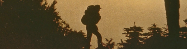 Backpacker silhouetted against the setting sun.