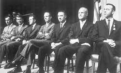 The first seven U.S. astronauts, selected for the Mercury program, were, left to right, Donald K. Slayton, Walter M. Schirra, Jr., Gordon Cooper, M. Scott Carpenter, Virgil I. Grissom, John H. Glenn, Jr., and Alan B. Shepard, Jr.