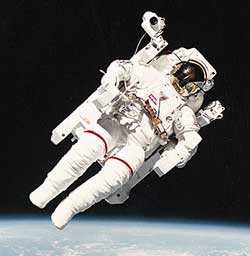 Flying free in space, an astronaut becomes a human satellite. A jet-powered backpack first used in 1984 allows astronauts to maneuver outside the spacecraft without a safety line.