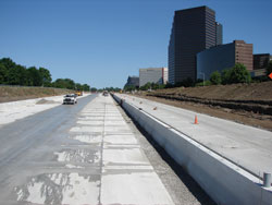 Figure 3. (b) Photograph. Lodge Freeway, Detroit, reconstructed during an extended closure for placement of jointed concrete pavement. A full closure in both directions with concrete pavement partially completed is shown.