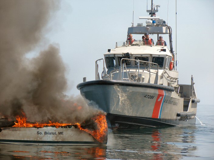 Picture of 47286 alongside a burning boat.