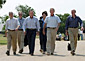 President Bush walks with his economic advisors at his ranch in Crawford, Texas.