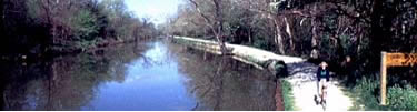 Bicyclist on canal towpath trail. 