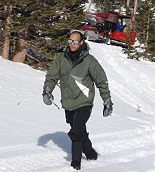 Derrick Lampkin walks along a snow-covered path in a forest