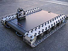 A flat rover with silver-colored tracks similar to those of an army tank