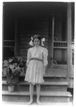 [Myrtle Bagwell, one of the youngest spinners in Spartan Mills, Spartanburg, S.C., standing on porch steps]