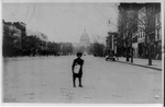 [William Parralla, 313 Second St., S.W., Washington, D.C., a 7 year old newsboy, standing on street with newspapers]