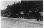[Street full of Baltimore immigrants lined up, with horse-drawn wagons, Wolfe Street near Canton Avenue, Baltimore, Maryland, to go to berry farms]
