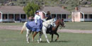 Lady and soldier on horseback Fort Davis NHS.