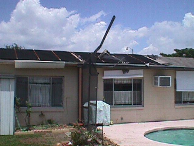 Picture of Home with pool screen cover destroyed.