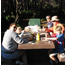 family seated at picnic table