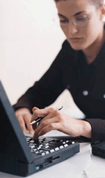 Woman typing an email at a laptop computer.