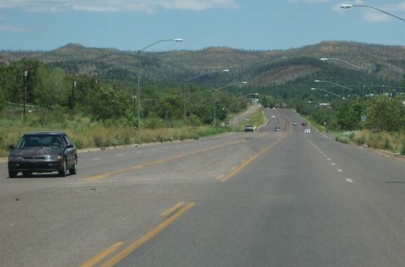 photo of a four lane road with a center turn lane