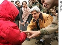 U.S. Senator John Kerry talks with Pakistani boy who survived the October 
8, 2005 earthquake at a camp near Mansera, Pakistan