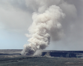 Fumes and ash roil skyward from the vent in Halemaumau crater