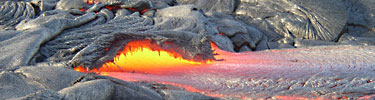Lava flows like a river out of a hardened crust.