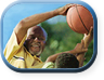 Older man and boy playing basketball