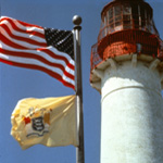 Cape May Point Lighthouse with US and NJ flags.