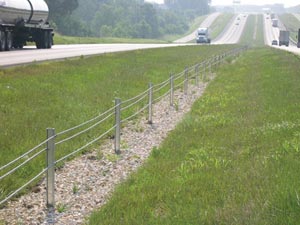 Fig. 11. Cable median barrier in median between two 2-lane highways. Traffic is moving on the highways.