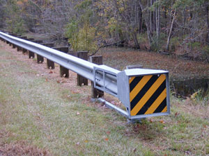 Fig. 10. View of a roadside guardrail that has yellow and black stripes on the end of it.