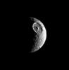 The great basin that interrupts the contours of this moon's crescent identifies the satellite unmistakably as Mimas. The giant crater Herschel (130 kilometers, or 80 miles wide) is this moon's most obvious feature