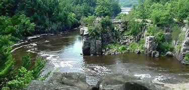 A narrow rocky gorge rises above the river
