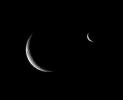 Rhea and Enceladus shared the sky just before the smaller moon passed behind its larger, cratered sibling.This image is part of a 