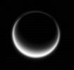 Sunlight scatters through Titan's atmosphere, illuminating high hazes and bathing the entire moon in a soft glow