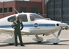 LARSS intern Tamara stands in a flight suit next to a Langley aircraft