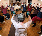 Photo of an older woman lifting weights in an exercise class