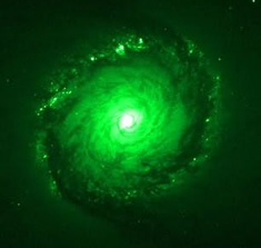 Bright green spiral shape with bright white nucleus.