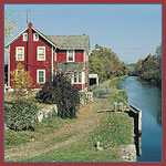 A red frame house along a canal