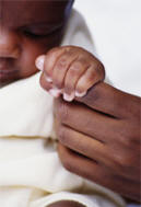 Baby holding finger