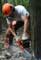 logger using chain saw to cut logs