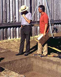 (photo) A park interpreter and an archeologist discuss excavated units at Ft. Vancouver National Historic Site.