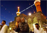 Iraqi Shiite Muslim pilgrims pray at the Imam Hussein holy shrine in Karbala on April 22, for the first time in decades. 