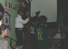 Indonesian rock star Ahmad Dhani sings with a group of street children who have received music training through Nurani Dunia at a charity Buka Puasa ,Iftaar, dinner with Under Secretary Hughes.