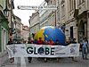 Students carry a banner with the word GLOBE in a parade